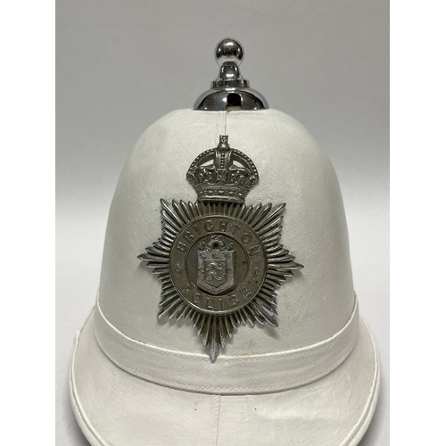 9261 - A Brighton Police white helmet with ball top, King’s crown badge, liner and chinstrap present