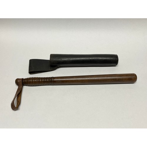 9177 - An early 20th Century hardwood policeman’s truncheon with ribbed grip, stamped CP with crown, leathe... 