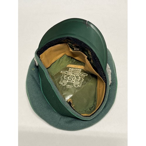 9113 - A mid 20th Century German Officer’s visor cap, signs of eagle badge having been mounted, dark green ... 