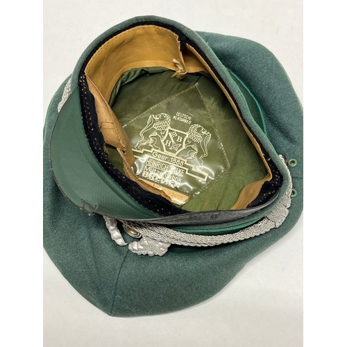 9113 - A mid 20th Century German Officer’s visor cap, signs of eagle badge having been mounted, dark green ... 