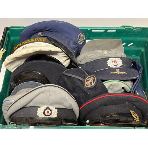 9050 - Two boxes of mixed headwear and webbing including post war British and German