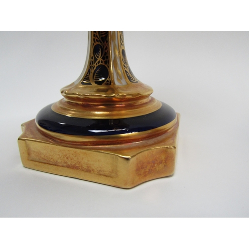 6223 - A pair of Royal Crown Derby Imari pattern urns, ovoid form with fixed knop cover and two high loop h... 