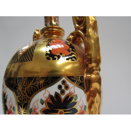 6223 - A pair of Royal Crown Derby Imari pattern urns, ovoid form with fixed knop cover and two high loop h... 