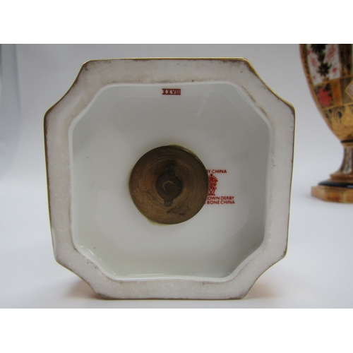 6223 - A pair of Royal Crown Derby Imari pattern urns, ovoid form with fixed knop cover and two high loop h... 