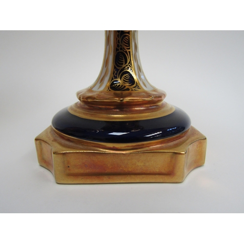 6223 - A pair of Royal Crown Derby Imari pattern urns, ovoid form with fixed knop cover and two high loop h... 