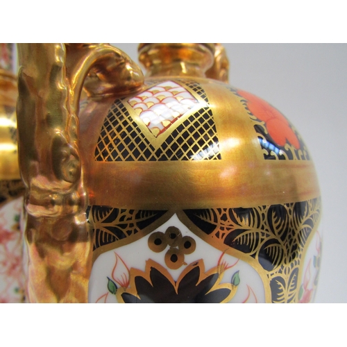 6223 - A pair of Royal Crown Derby Imari pattern urns, ovoid form with fixed knop cover and two high loop h... 