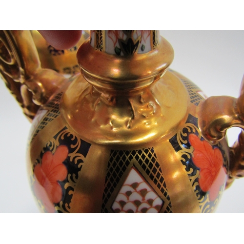 6223 - A pair of Royal Crown Derby Imari pattern urns, ovoid form with fixed knop cover and two high loop h... 