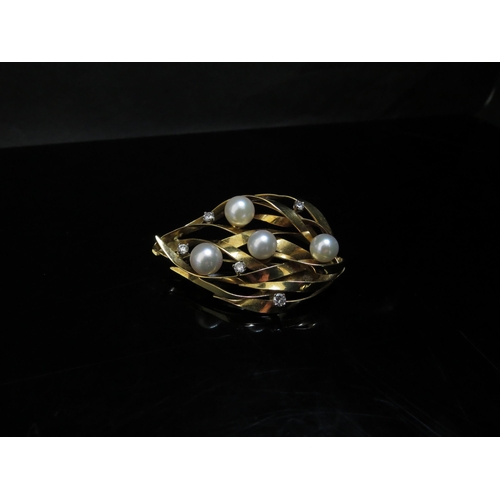 6233 - An 18ct gold brooch of leaf form set with four pearls and five diamond chips, 13g