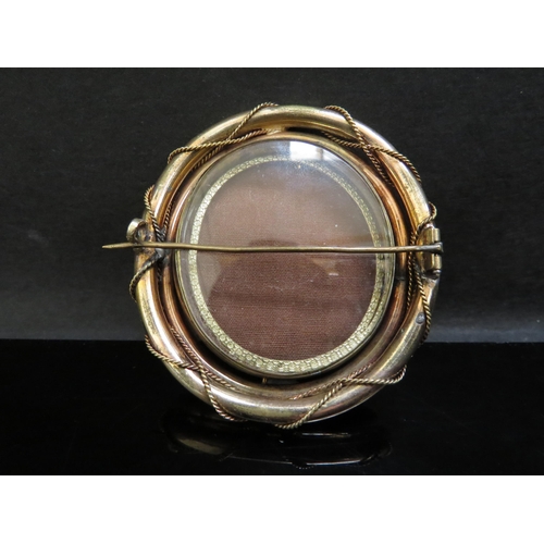 6236 - A large cameo brooch depicting a female playing the harp, 6.5cmx 6cm with a vacant glass panel back ... 