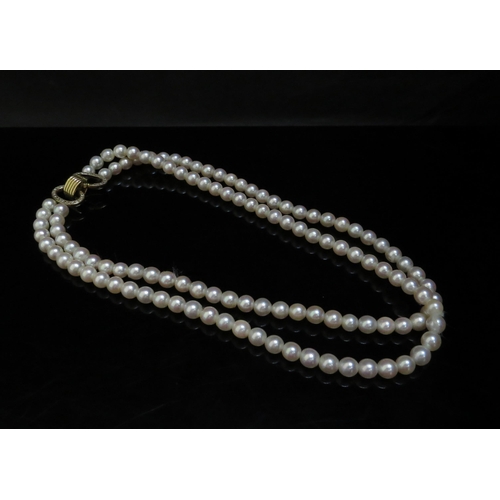 6249 - A double stranded pearl necklace 19cm long, diamond encrusted clasp, 42cm long    (R) £200