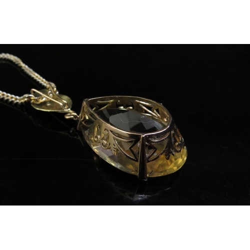 6248 - A large pear shaped citrine pendant, 4cm long in 14ct gold mount with later applied 18ct gold leaf m... 