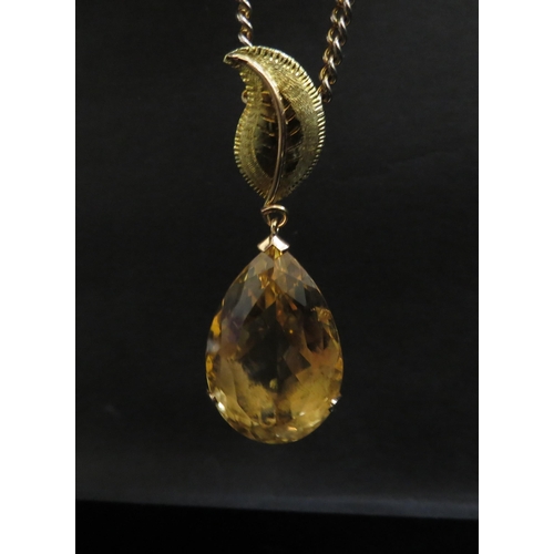 6248 - A large pear shaped citrine pendant, 4cm long in 14ct gold mount with later applied 18ct gold leaf m... 