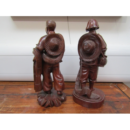 6043 - Eastern carved wood figures, 27cm tall