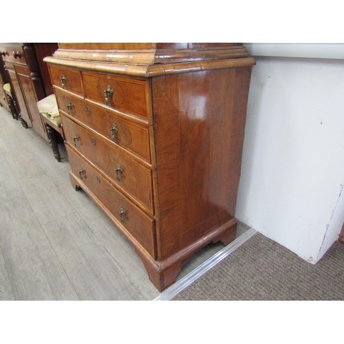 6067 - A William & Mary burr walnut veneered cabinet on chest, ogee pediment over single top drawer. The do... 