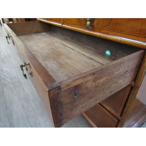 6067 - A William & Mary burr walnut veneered cabinet on chest, ogee pediment over single top drawer. The do... 