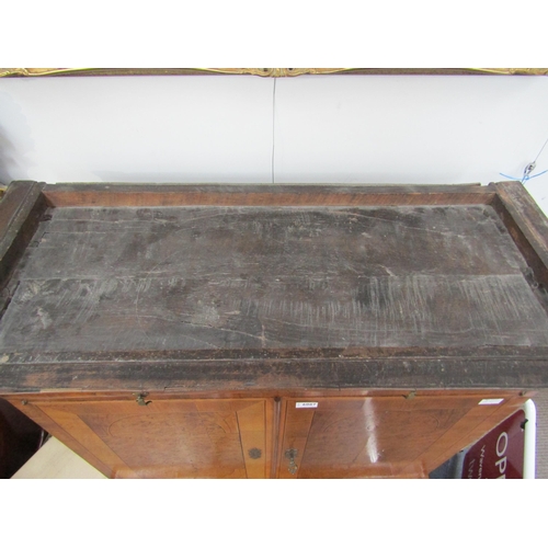 6067 - A William & Mary burr walnut veneered cabinet on chest, ogee pediment over single top drawer. The do... 