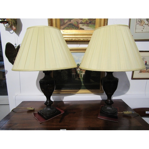 6079 - A pair of modern antiqued bronze effect metal brass form lamps with pleated cream shades, 67cm tall,... 