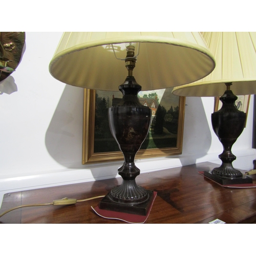 6079 - A pair of modern antiqued bronze effect metal brass form lamps with pleated cream shades, 67cm tall,... 