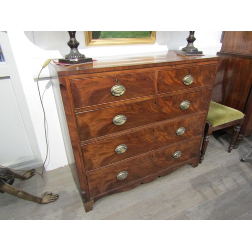 6081 - A Georgian mahogany two over three chest of drawers with oval plate handles, shaped apron, canted co... 