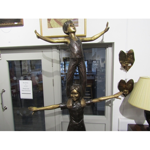 6082 - A bronze sculpture of three children balancing on each other, 222cm tall approx     (C)