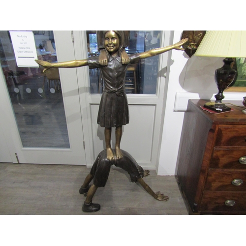 6082 - A bronze sculpture of three children balancing on each other, 222cm tall approx     (C)