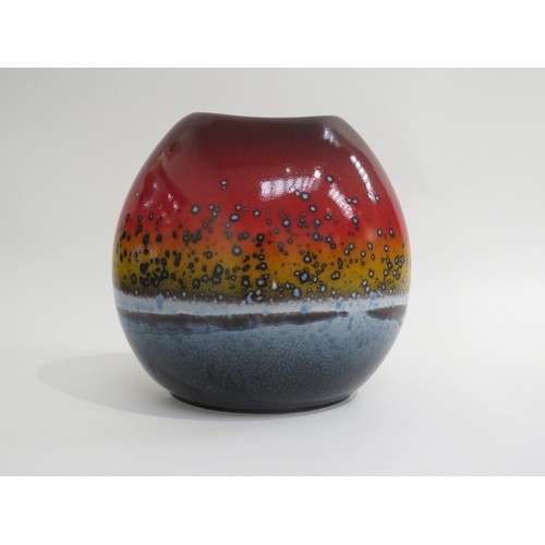 9048 - A Poole Pottery 'Sunset' vase of purse form in reds, ochre and blues. Marks to base. 18cm high