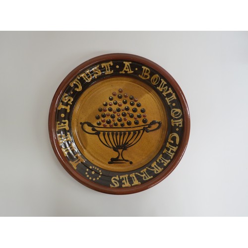 9097 - A Bredon Pottery slipware charger by Tony & Sue Davies, 'Life Is Just A Bowl Of Cherries'. Label ver... 