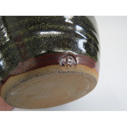 9087 - A Winchcombe Pottery tenmoku glazed stoneware jug. Impressed pottery seal. 21cm high