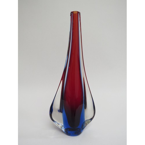 9157 - A Murano glass slender vase in red and blue encased in clear with 'fin' sides. 27.5cm high