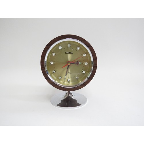 9250 - A c1970's Coral pedestal clock, wood finish on a chromed plastic tulip base. 16cm high