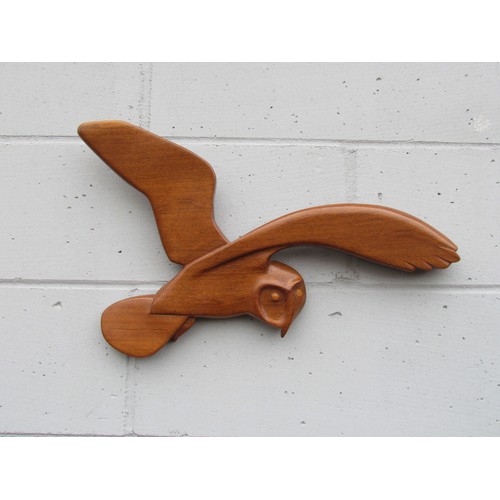 9417 - A teak wall hanging of a Barn Owl in flight. Marked 'K' verso. 35cm tall x 59cm wide