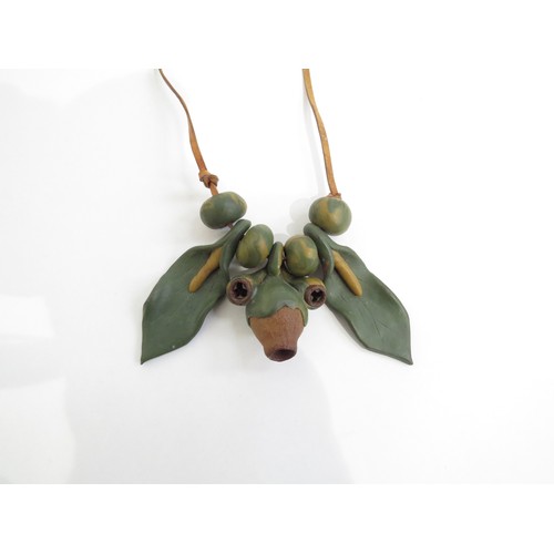 9225 - A 1970's seed pod and clay organic necklace on leather thong.   (C)