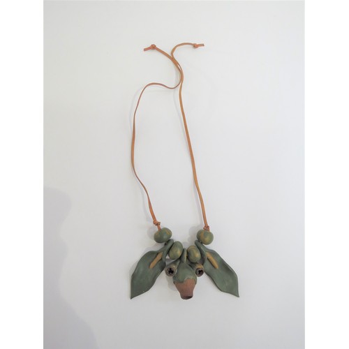 9225 - A 1970's seed pod and clay organic necklace on leather thong.   (C)