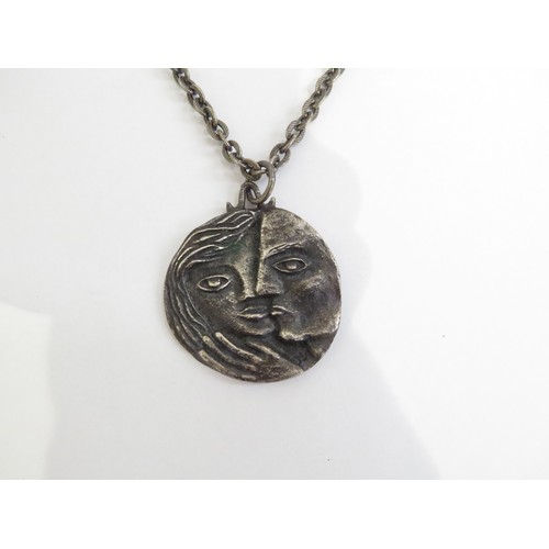 9238 - A 1960's pewter pendant necklace featuring male and female heads.   (C)