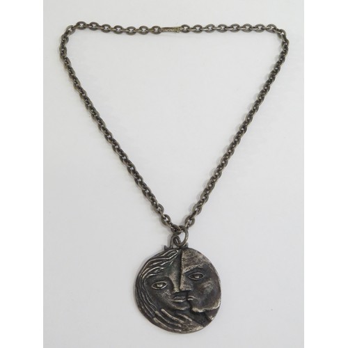 9238 - A 1960's pewter pendant necklace featuring male and female heads.   (C)