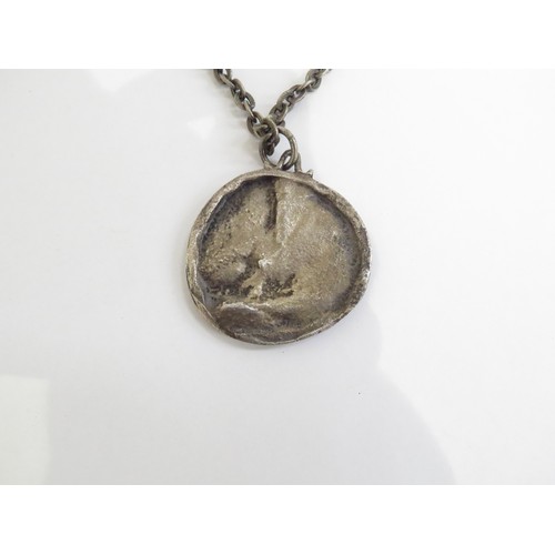 9238 - A 1960's pewter pendant necklace featuring male and female heads.   (C)