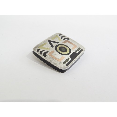 9239 - A 1980's Mexican sterling silver brooch with Aztec inlaid design. Marks to the reverse.