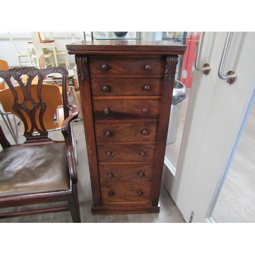 6086 - A 19th Century mahogany wellington chest of seven graduating drawers (one handle damaged), key with ... 