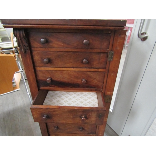 6086 - A 19th Century mahogany wellington chest of seven graduating drawers (one handle damaged), key with ... 