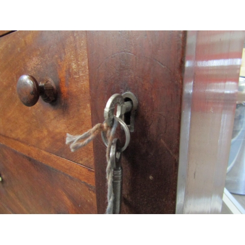 6086 - A 19th Century mahogany wellington chest of seven graduating drawers (one handle damaged), key with ... 