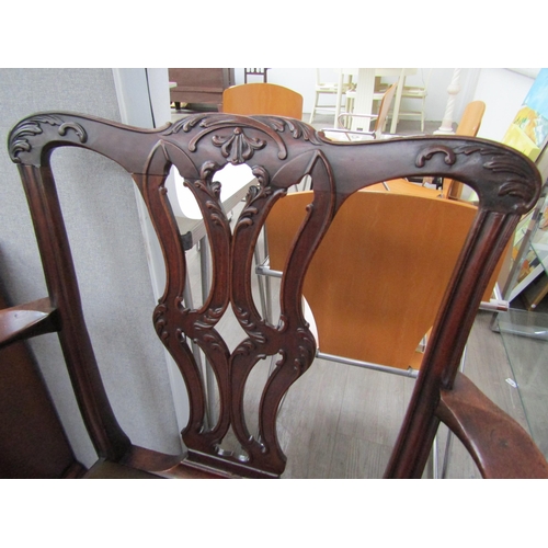 6087 - A Georgian mahogany armchair with carved acanthus leaf pierced central splat over a leather seat and... 
