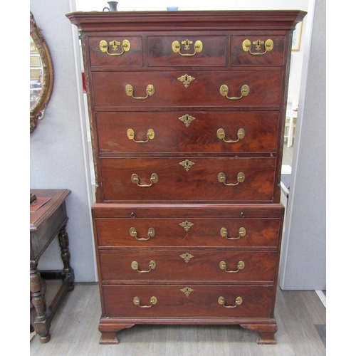 6092 - A Georgian mahogany chest on chest, three small drawers over three long graduating drawers to top an... 