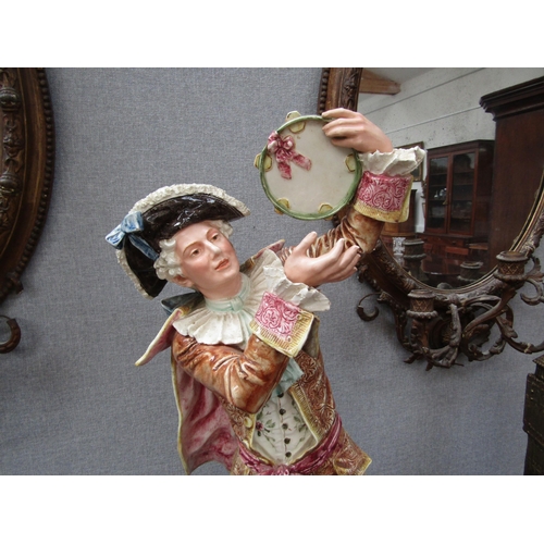 6096 - An early 20th Century ceramic figure of a gent with tambourine, 78cm height