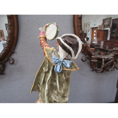 6096 - An early 20th Century ceramic figure of a gent with tambourine, 78cm height
