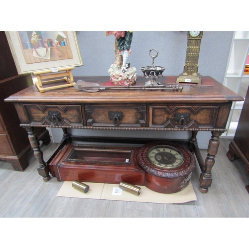 6098 - A 19th Century Jacobean style oak three drawer sideboard with heavy wrought iron handles (moulding m... 