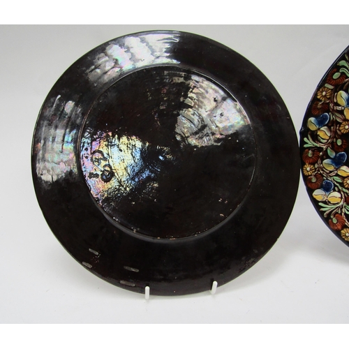 6103 - A pair of Continental glazed and painted clay wall plates, 26.5cm diameter