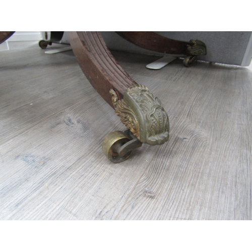 6106 - A Regency mahogany sofa table with two drawers turned stem to quatraform base, reeded legs to cup ca... 