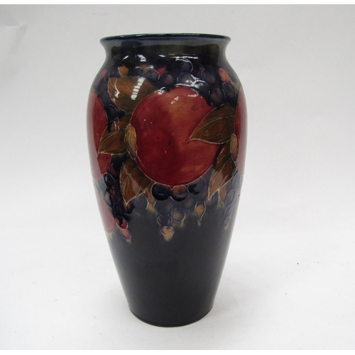 6117 - A William Moorcroft pomegranate vase, 25cm tall