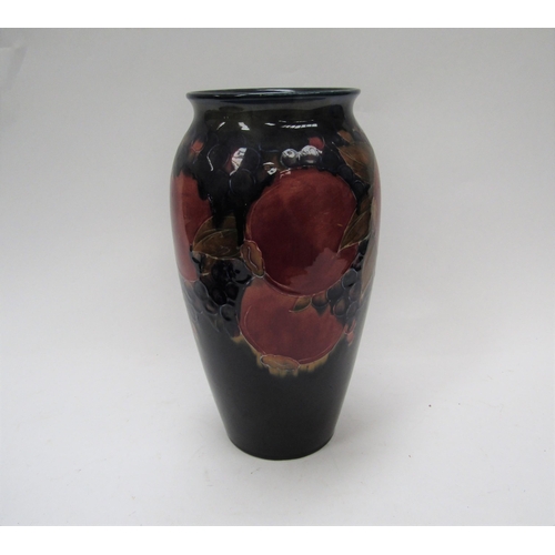6117 - A William Moorcroft pomegranate vase, 25cm tall