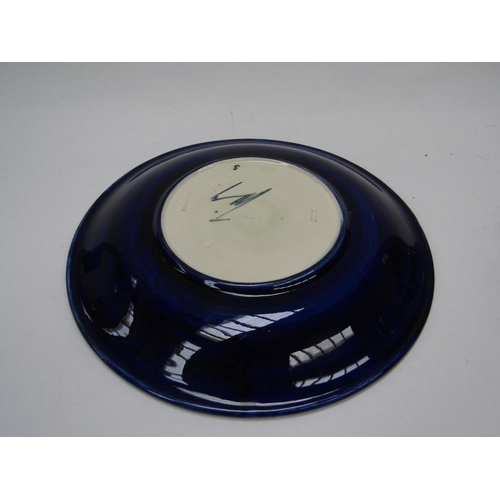 6118 - A Moorcroft Clematis pattern plate on blue ground, 26cm diameter